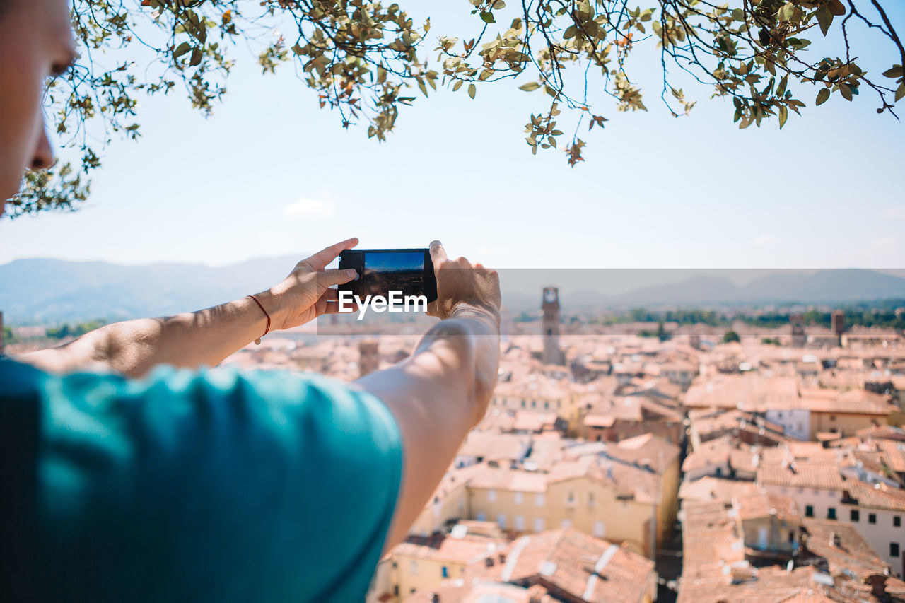 MAN PHOTOGRAPHING WITH MOBILE PHONE