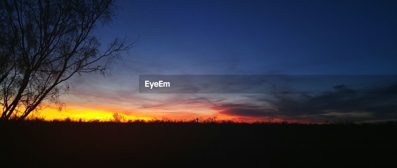 Scenic view of silhouette landscape against sky during sunset