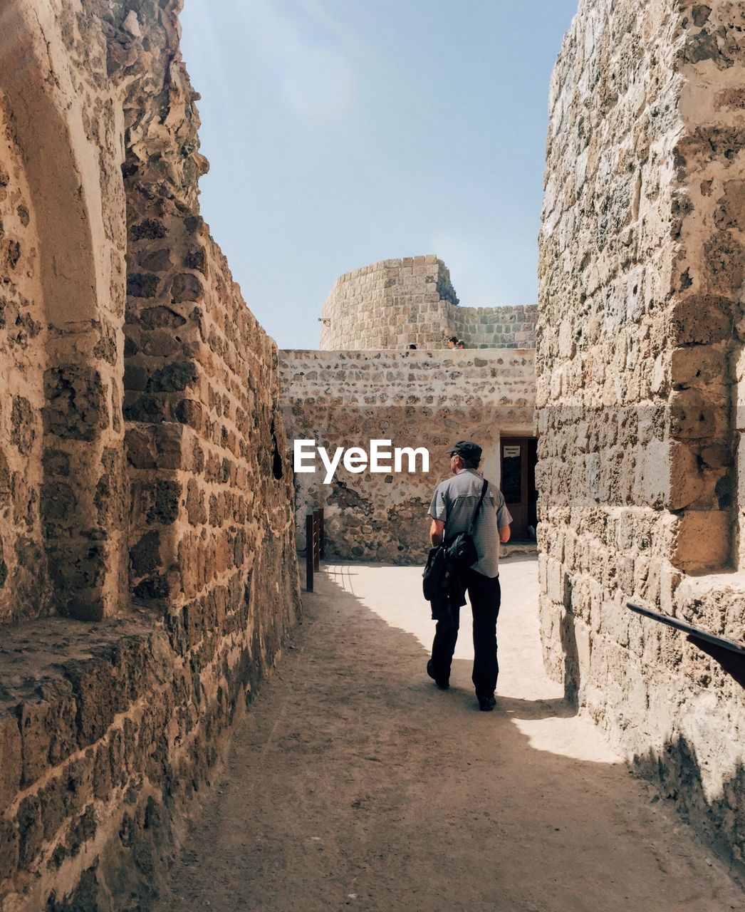 Full length of man walking amidst old ruin