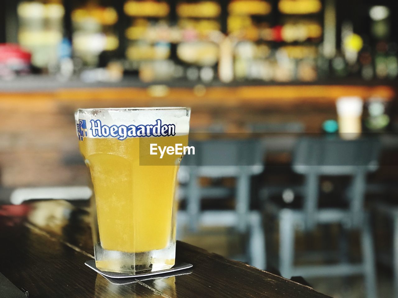 CLOSE-UP OF BEER IN GLASS ON TABLE AT CAFE