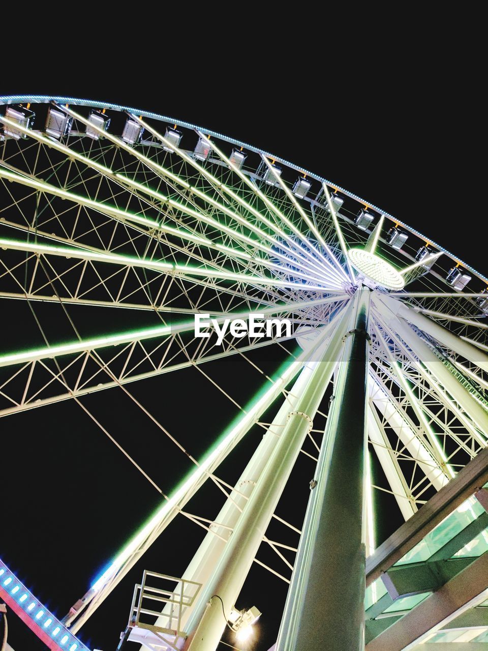 LOW ANGLE VIEW OF ILLUMINATED FERRIS WHEEL