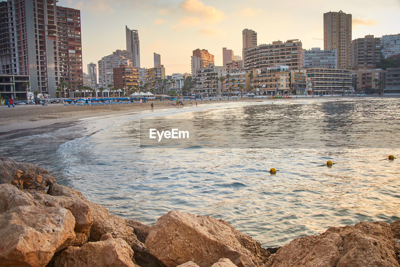 Scenic view of sea and buildings against sky