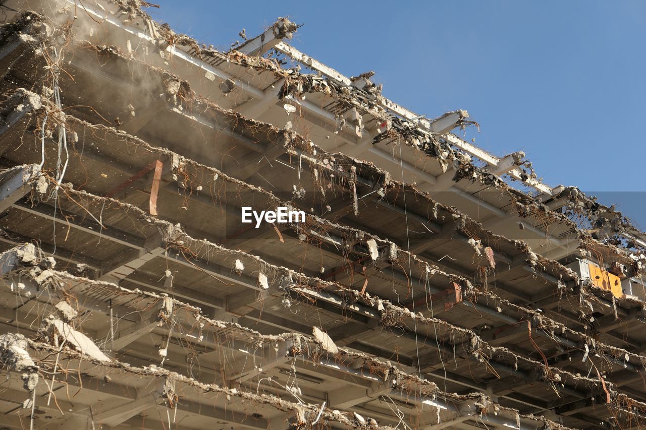 Low angle view of abandoned building against sky