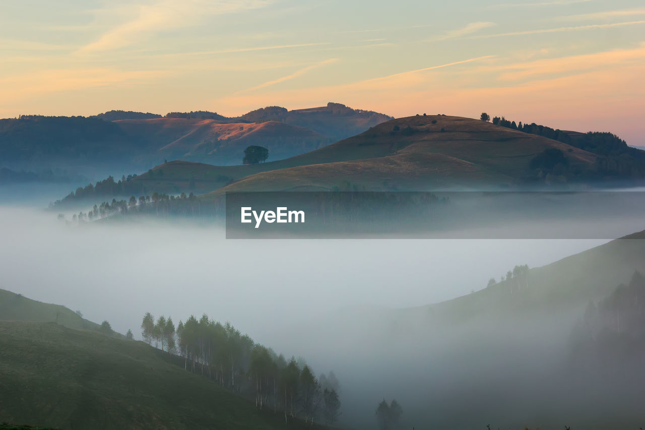 Scenic view of mountains against sky during sunset