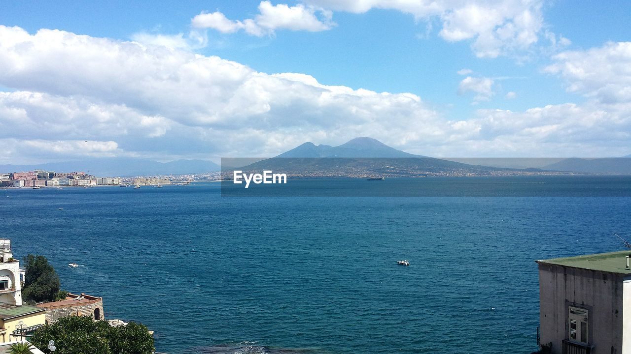 Scenic view of gulf of naples against cloudy sky