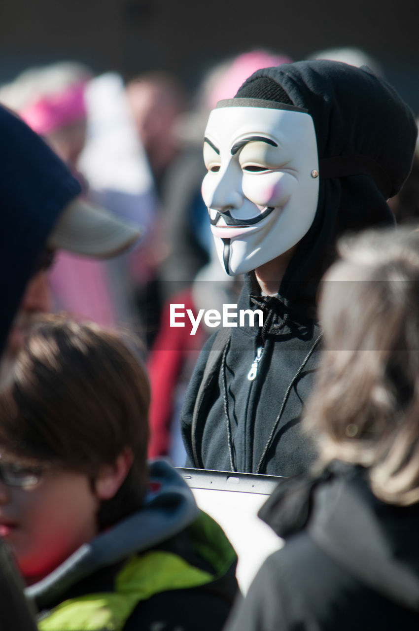 Man wearing mask during protest in city