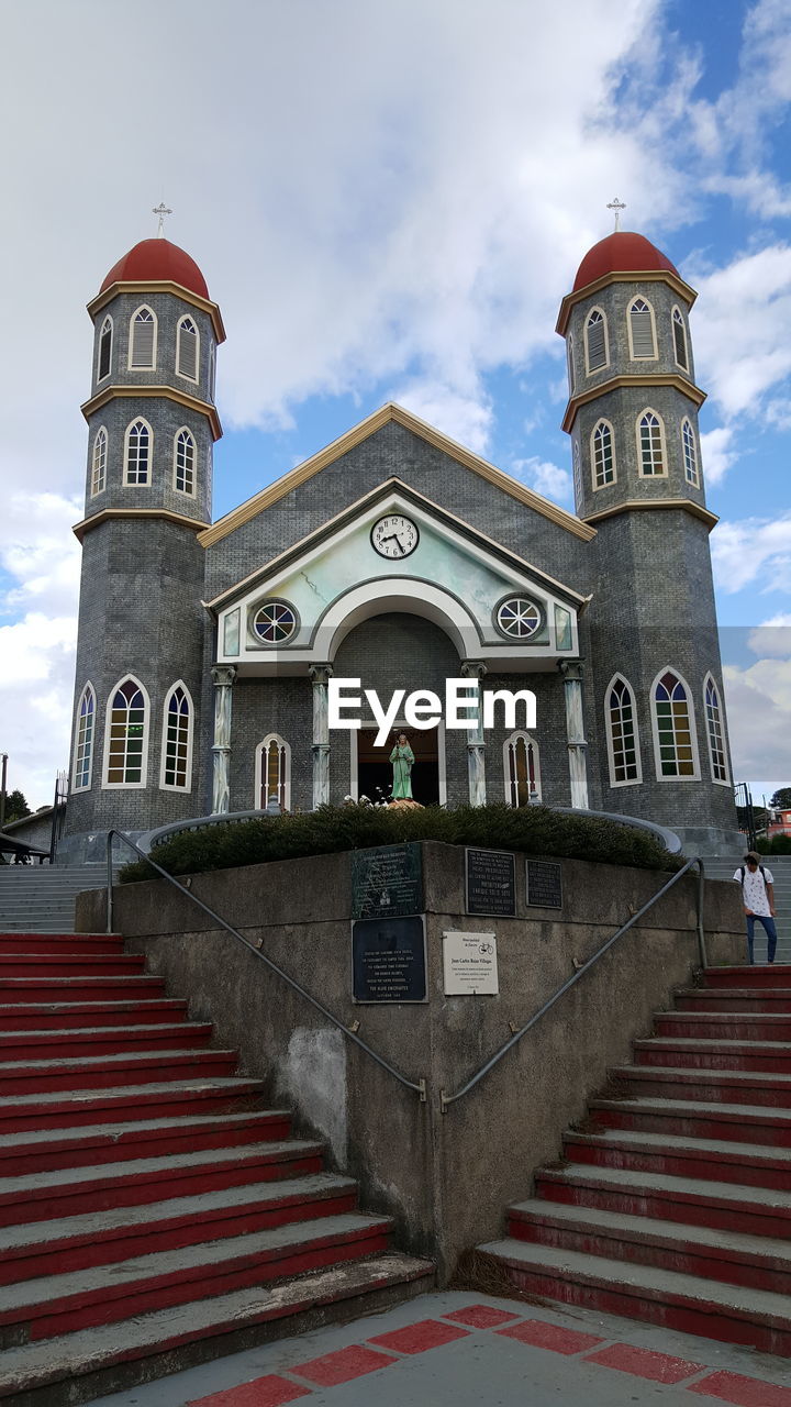 Low angle view of clock tower against sky