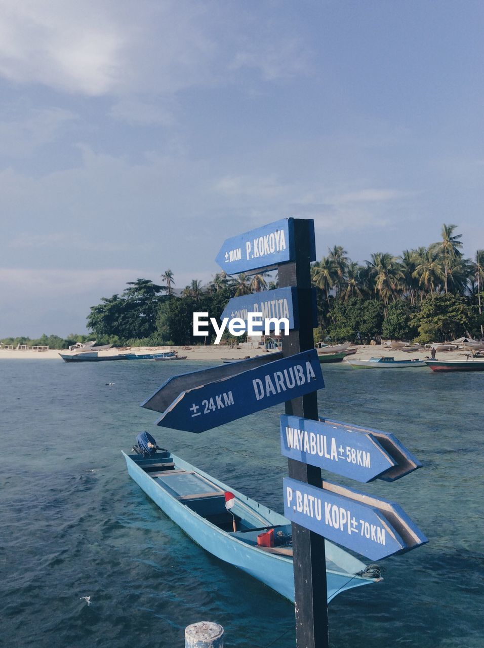 High angle view of information sign by sea against sky