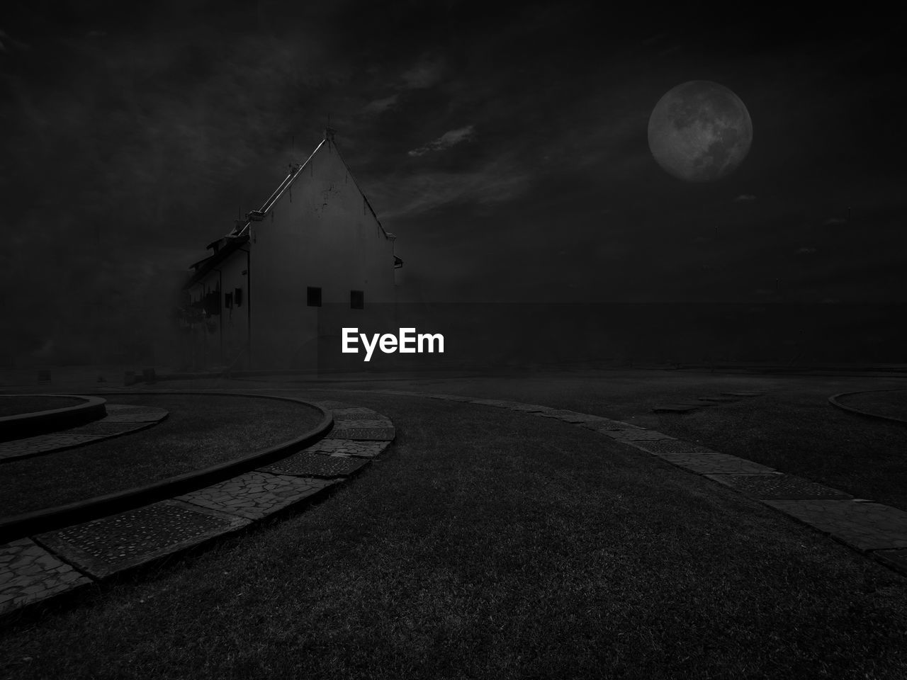 WINDMILLS AGAINST SKY AT NIGHT IN CITY