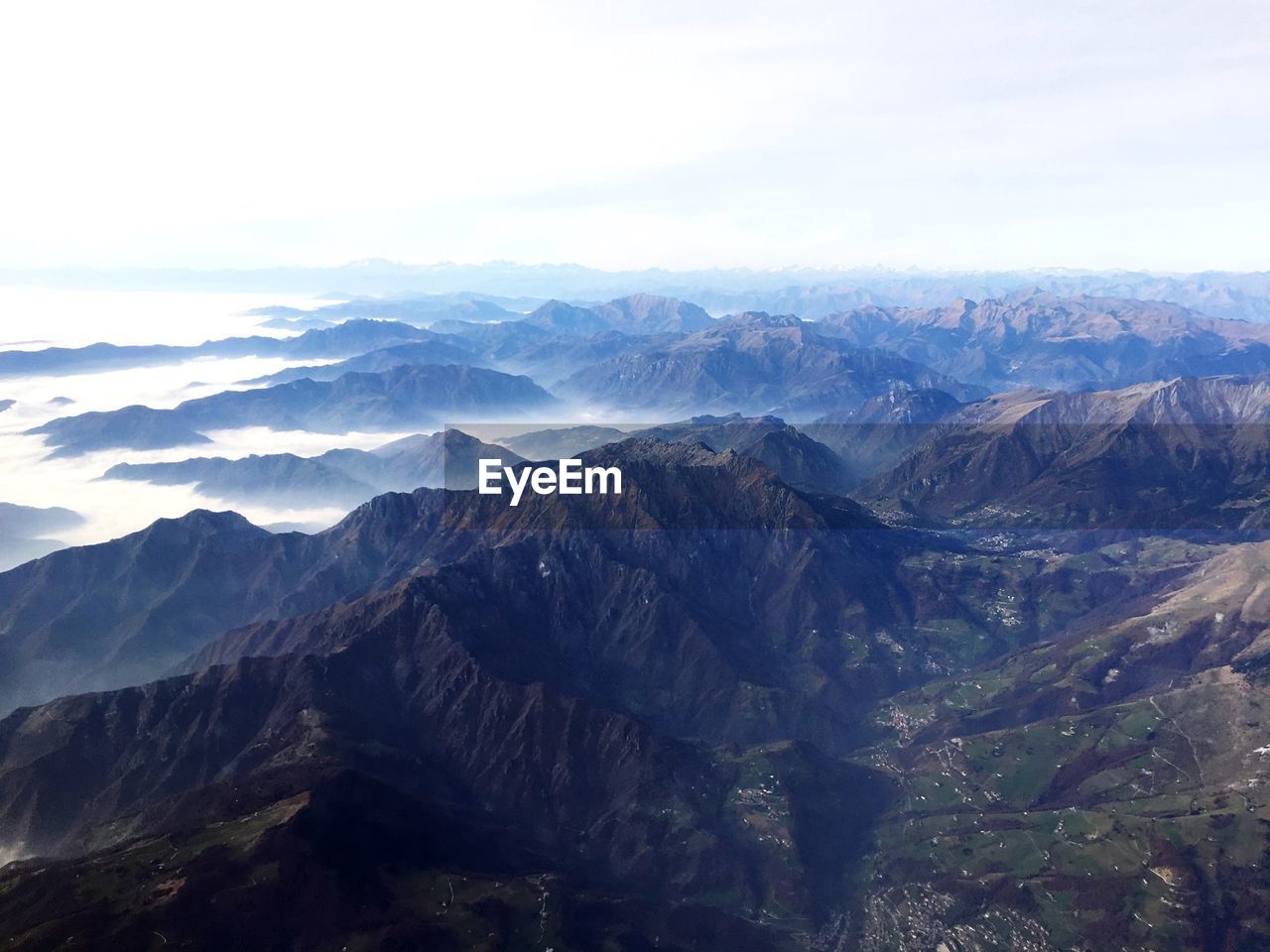 Scenic view of mountain range against cloudy sky