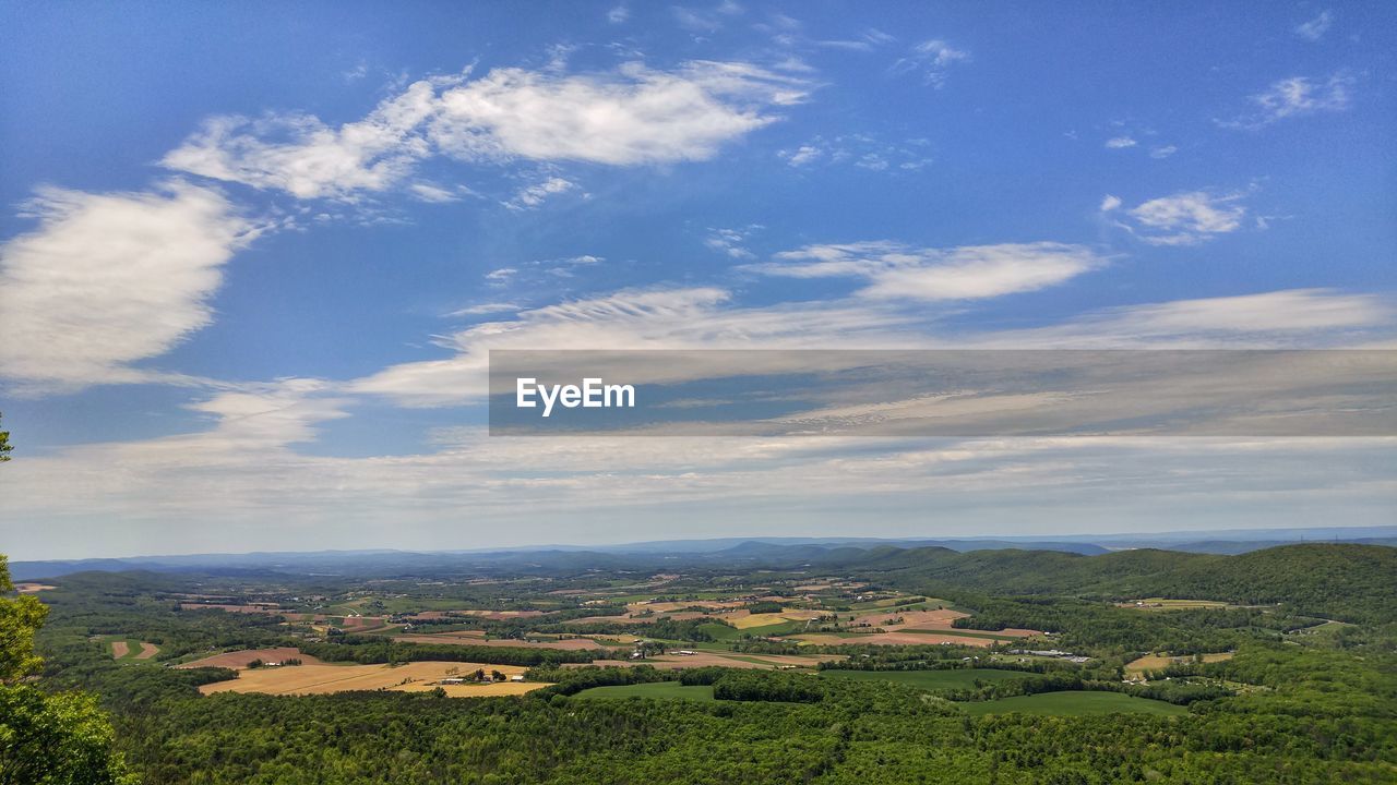 Scenic view of landscape against blue sky