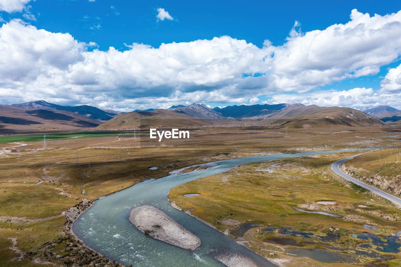 environment, landscape, scenics - nature, mountain, sky, cloud, beauty in nature, nature, water, snow, land, travel, mountain range, travel destinations, cold temperature, lake, wilderness, no people, tranquility, blue, road, non-urban scene, winter, tranquil scene, tourism, plateau, outdoors, day, ice, snowcapped mountain, highland, social issues, rural scene, transportation, mountain pass, reservoir, plain, environmental conservation, valley, tundra, aerial photography, grass, idyllic, glacier