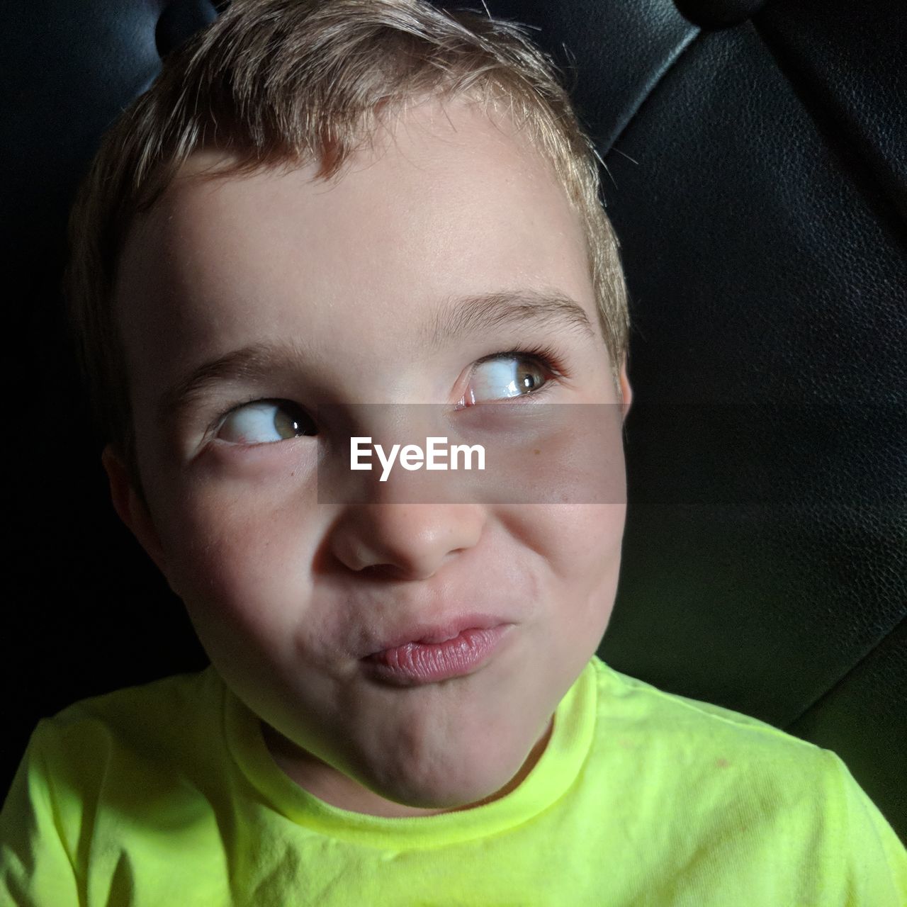 Close-up of smiling boy looking away