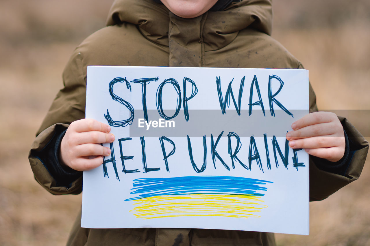 War of russia against ukraine. crying boy asks to stop the war in ukraine.