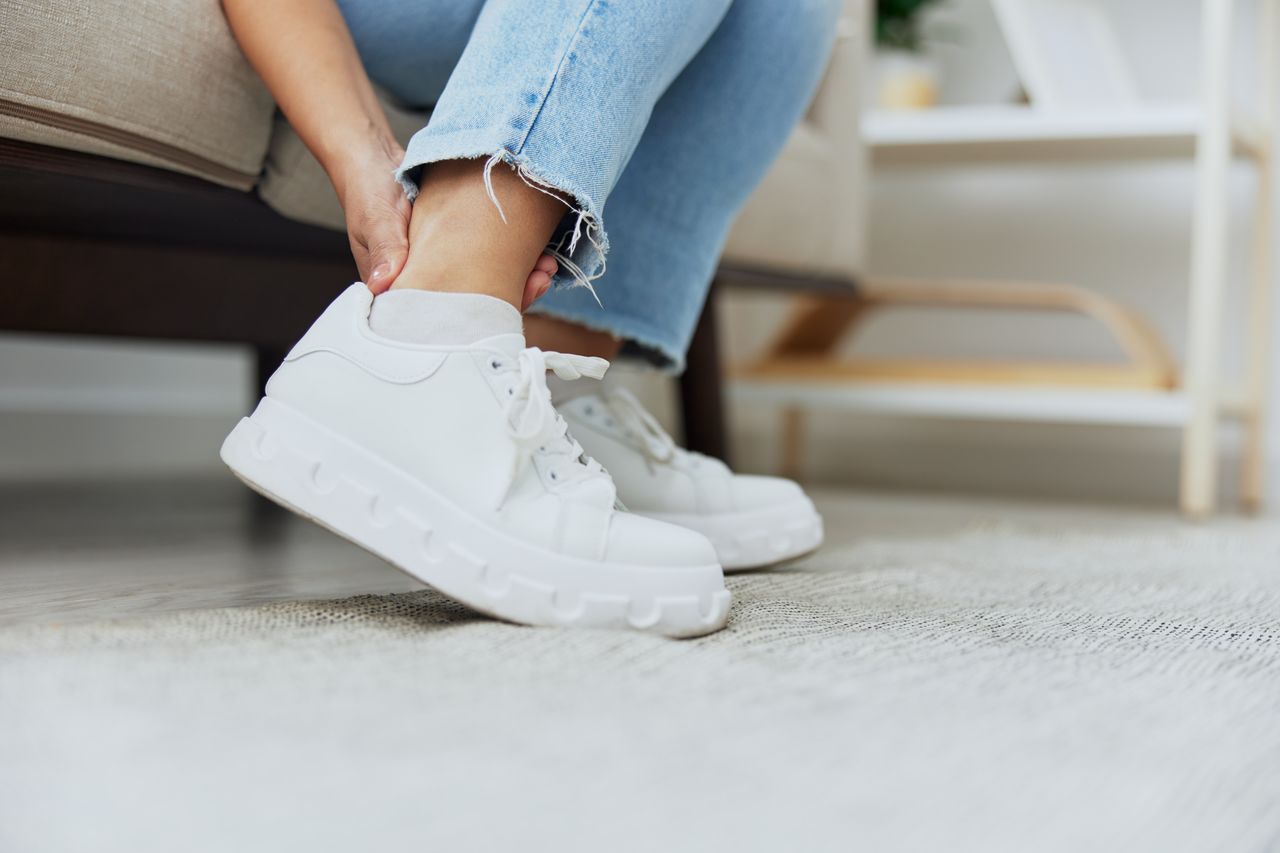 low section of woman tying shoelace