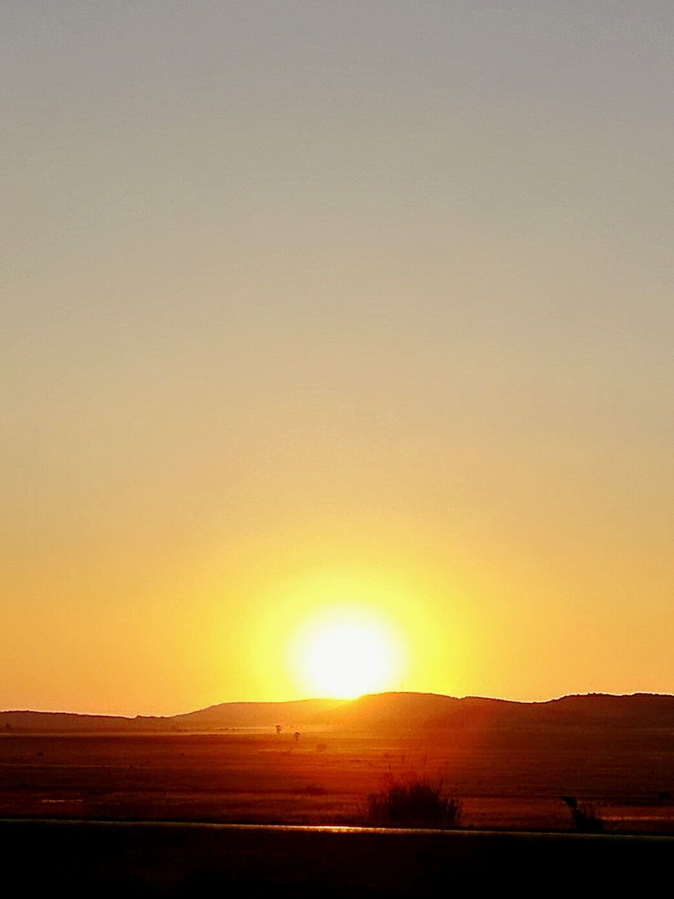 SCENIC VIEW OF SUNRISE AGAINST SKY AT SUNSET