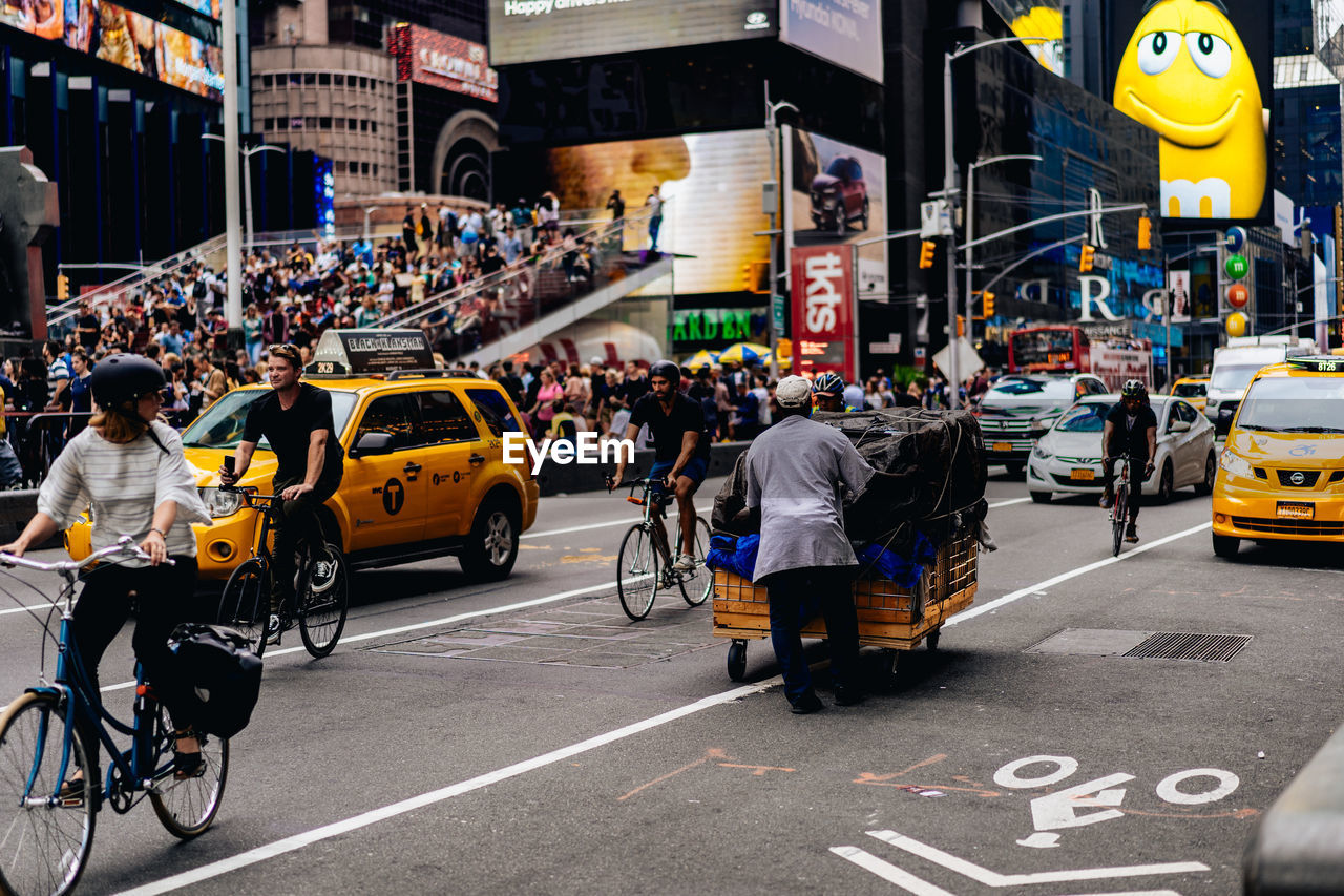 PEOPLE ON CITY STREET