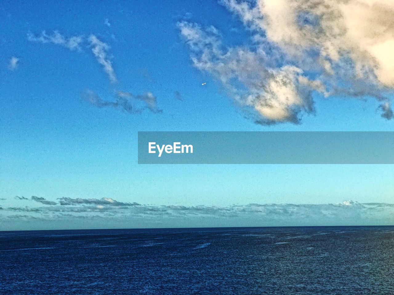 SCENIC VIEW OF BEACH AGAINST BLUE SKY