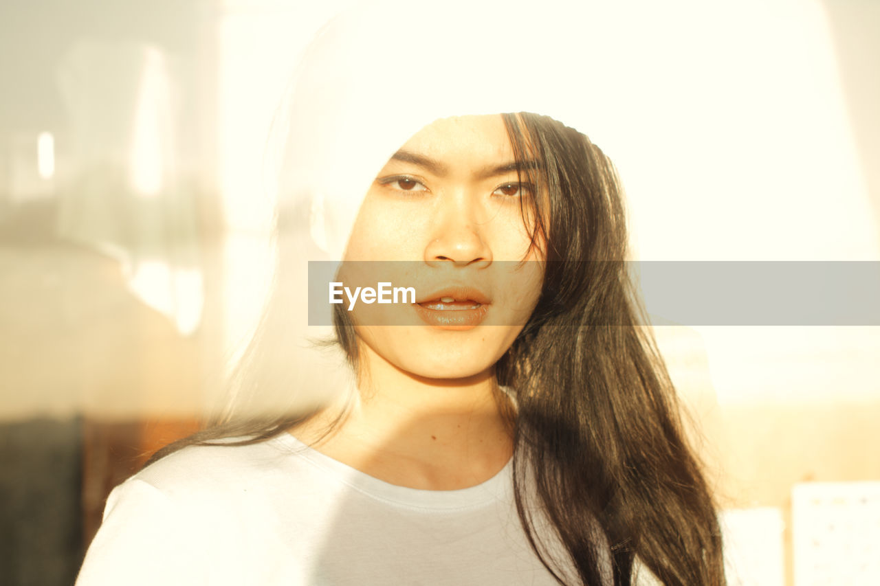 Close-up portrait of woman outdoors in sunny day