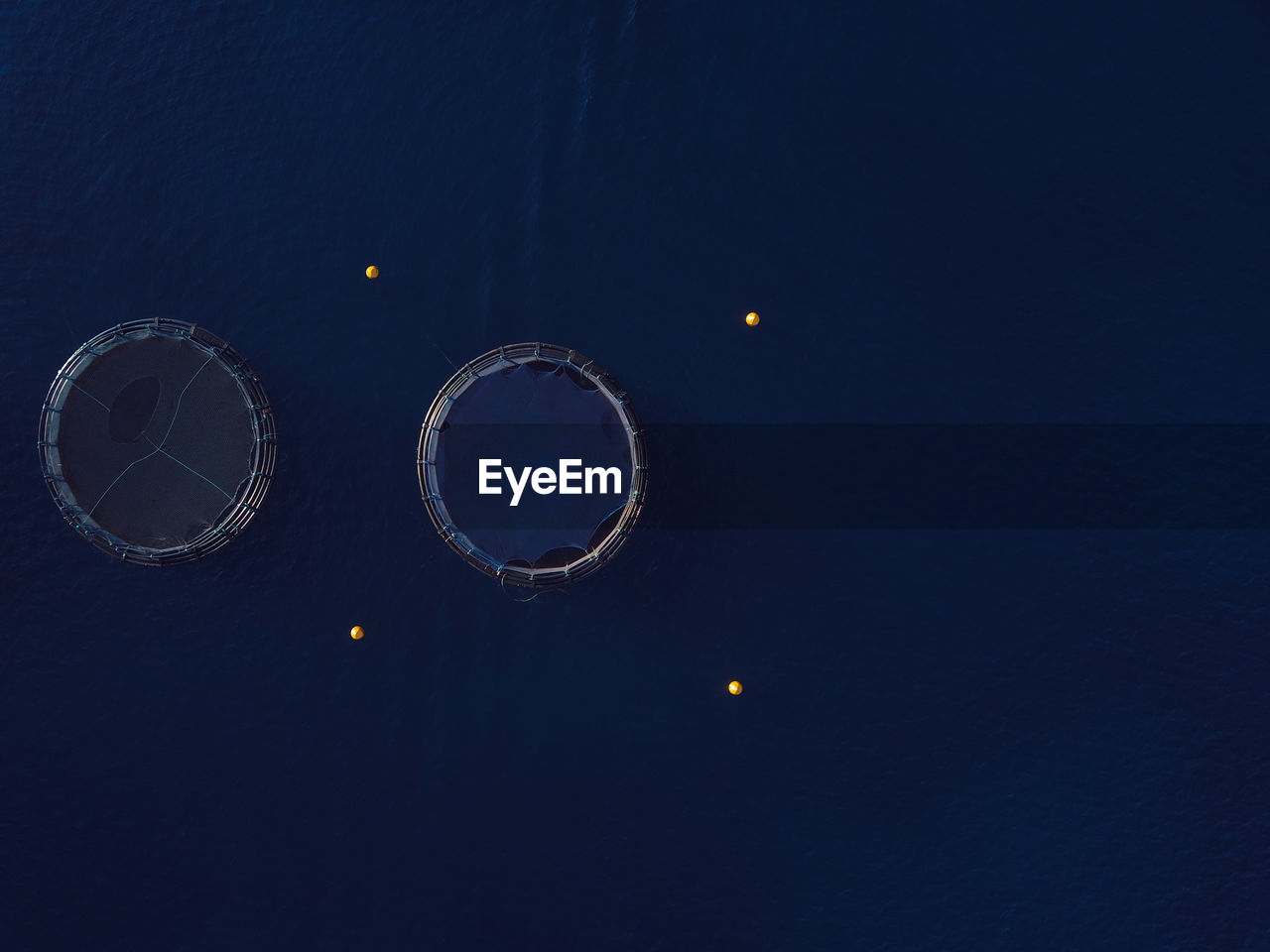 Aerial view of fish farm cages.