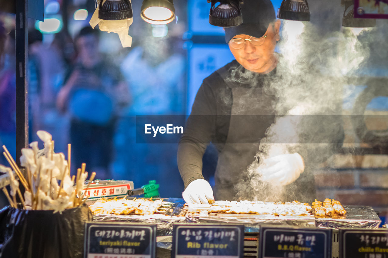 MAN WORKING ON MARKET STALL