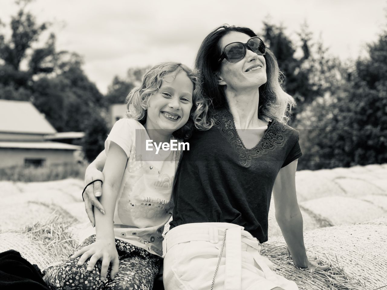 Portrait of smiling daughter sitting with mother