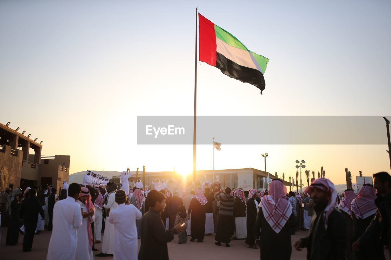 United arab emirates flag against clear sky during al janadriyah festival