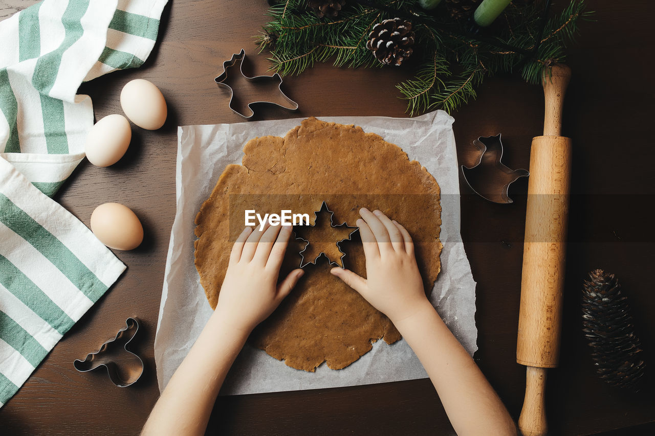 Little girl is baking christmas gingerbread cookies. high quality photo