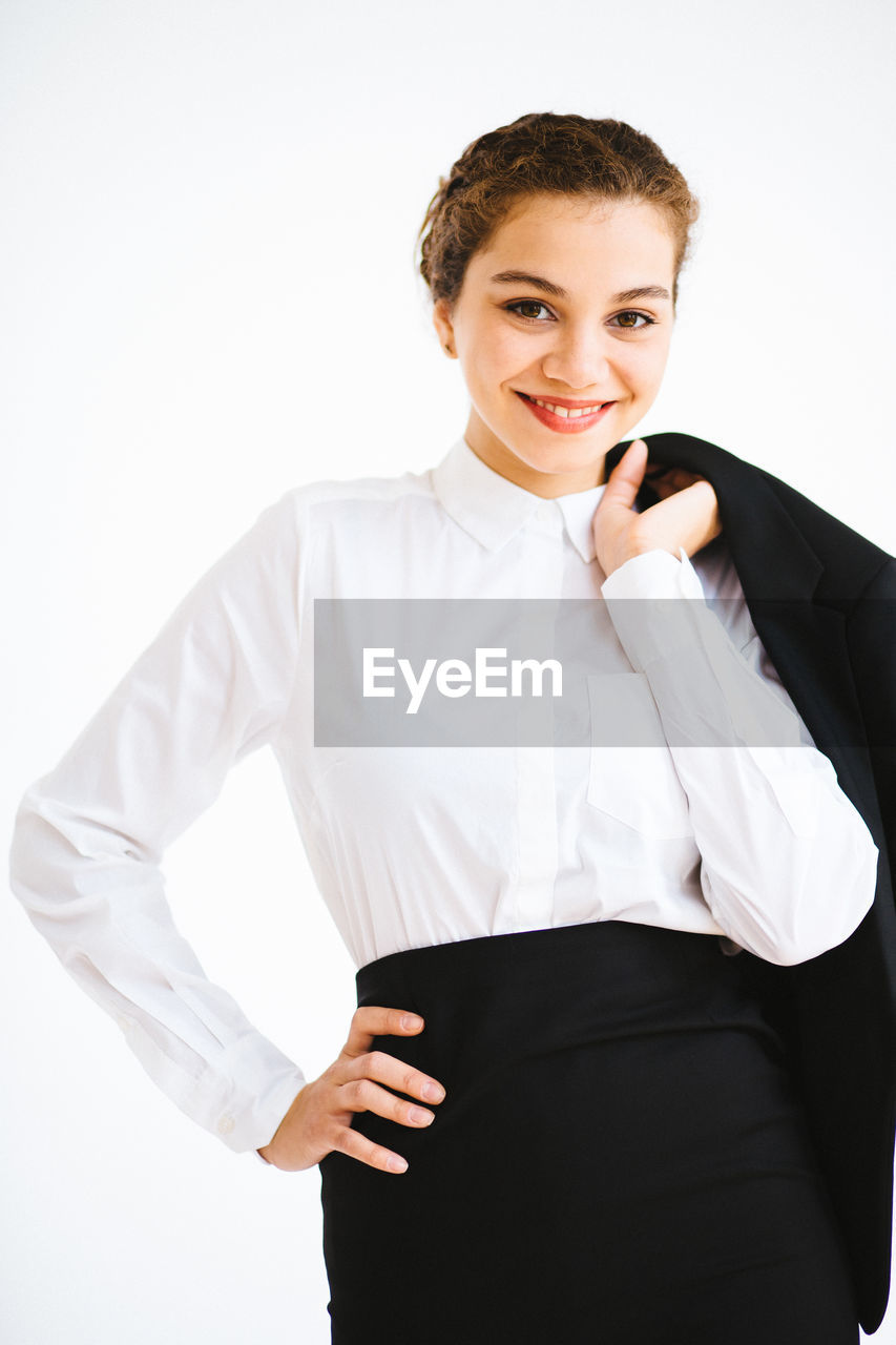 Portrait of businesswoman smiling over white background