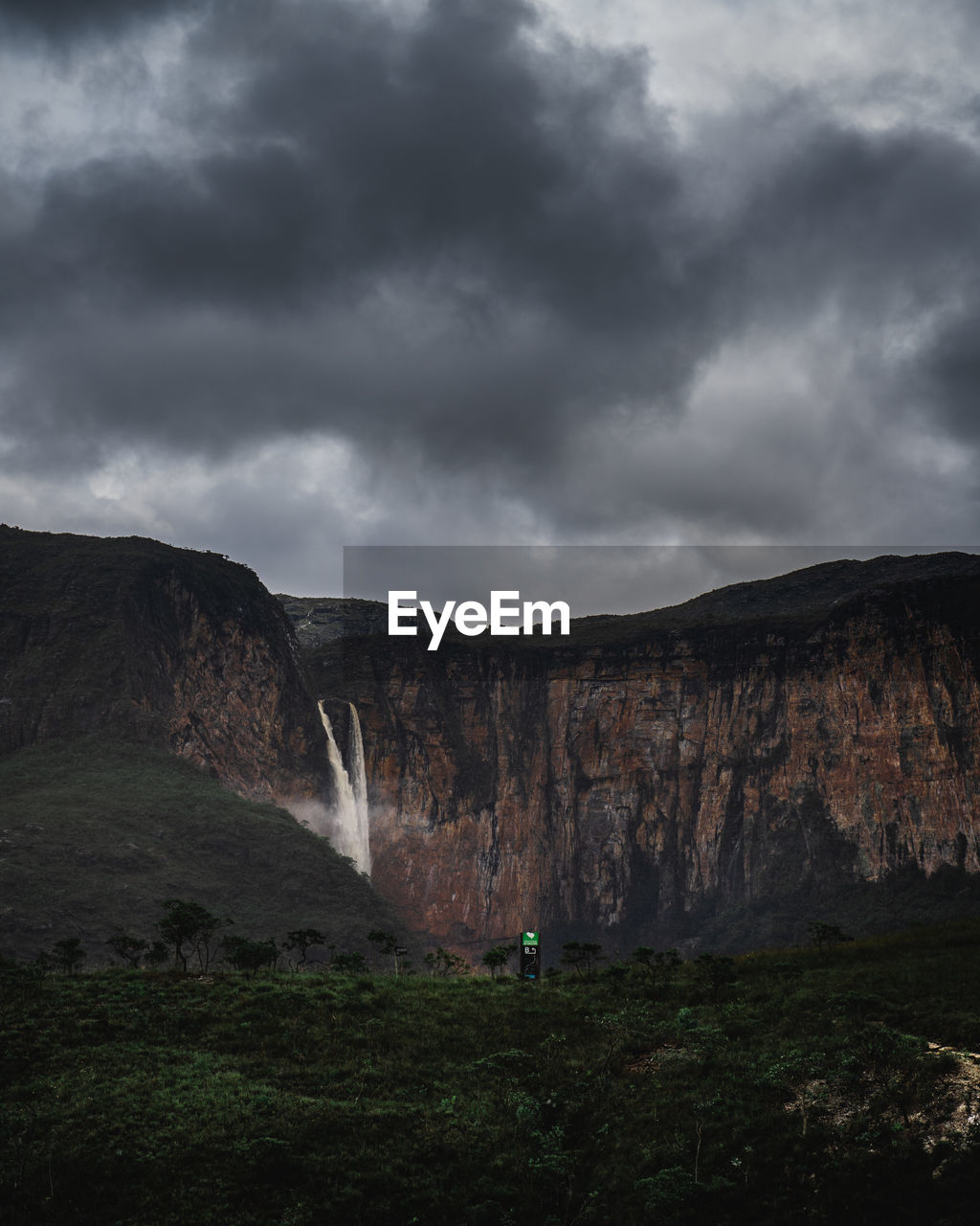 Scenic view of mountain against cloudy sky