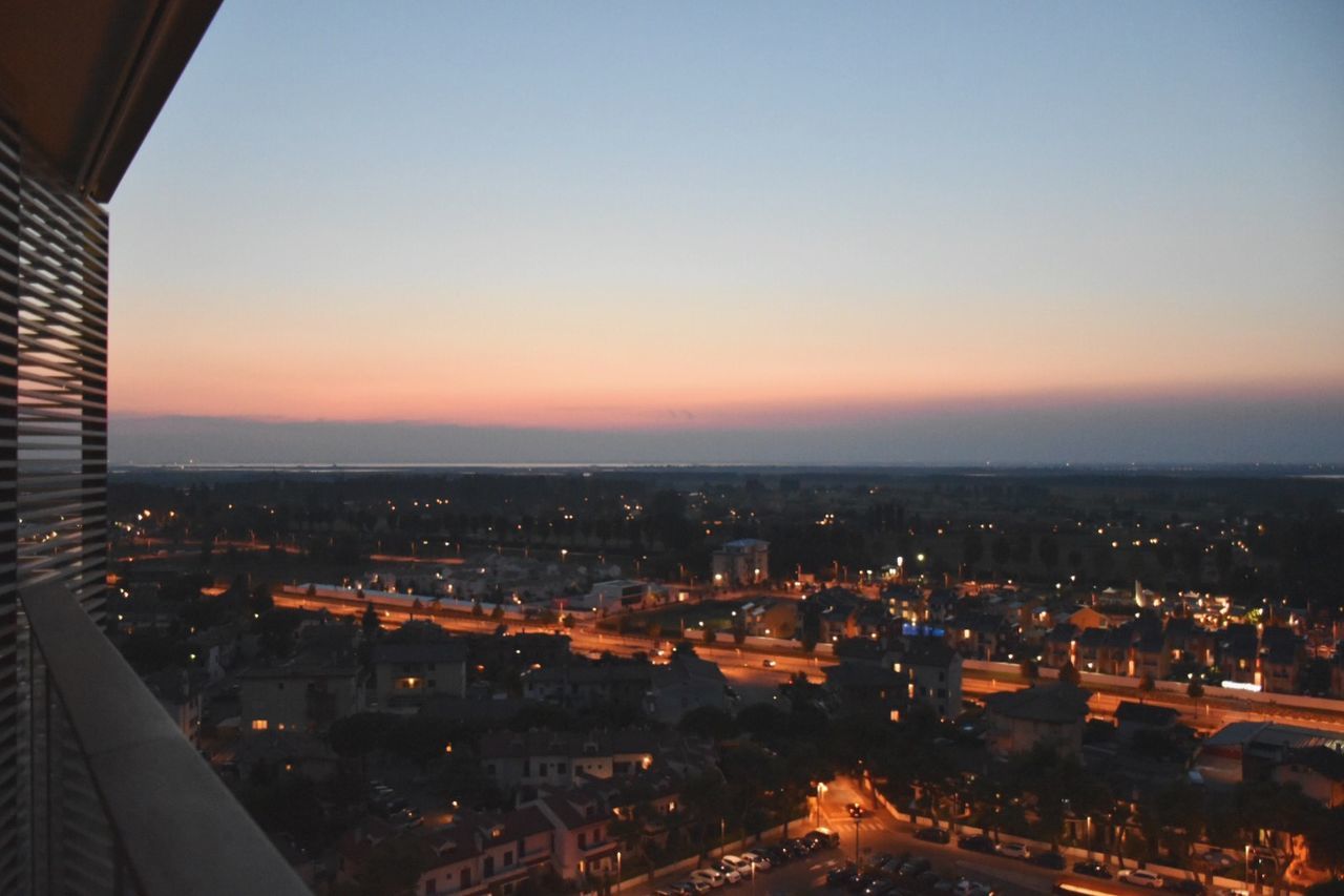 VIEW OF ILLUMINATED CITYSCAPE