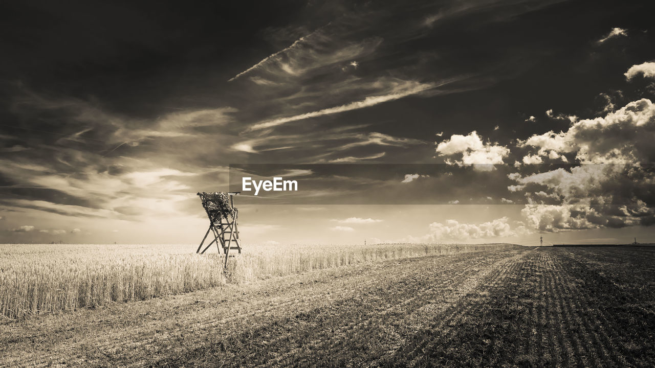 WINDMILL ON FIELD AGAINST SKY