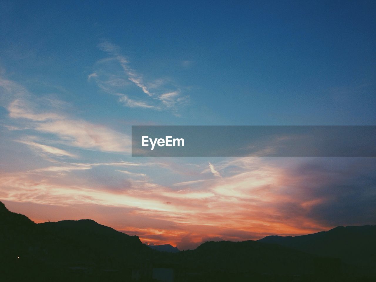 Scenic view of mountain against sky at dusk