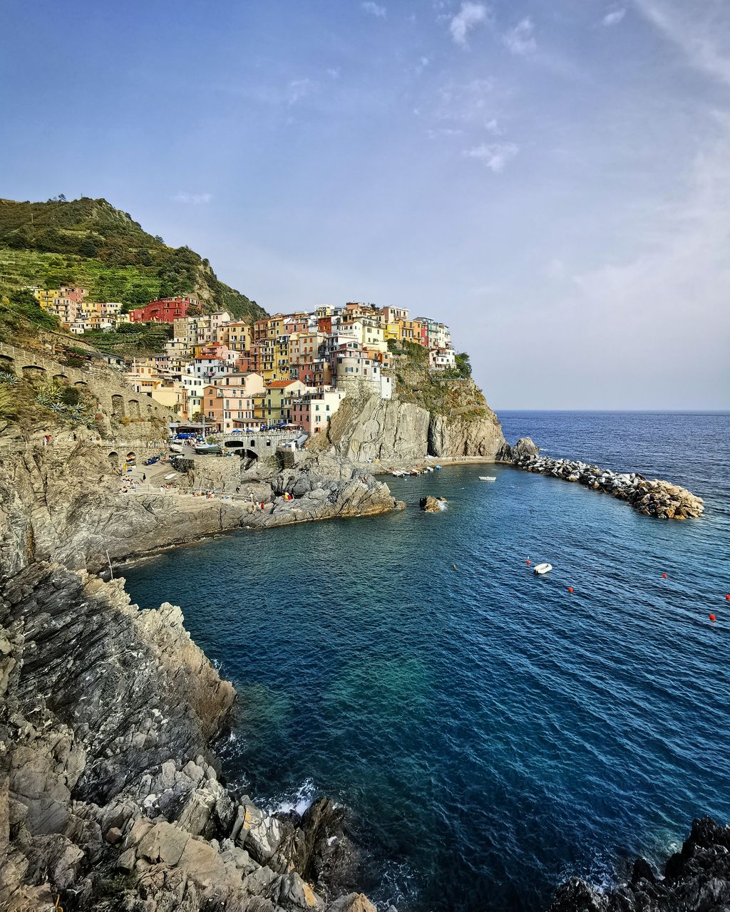 Scenic view of sea by buildings against sky