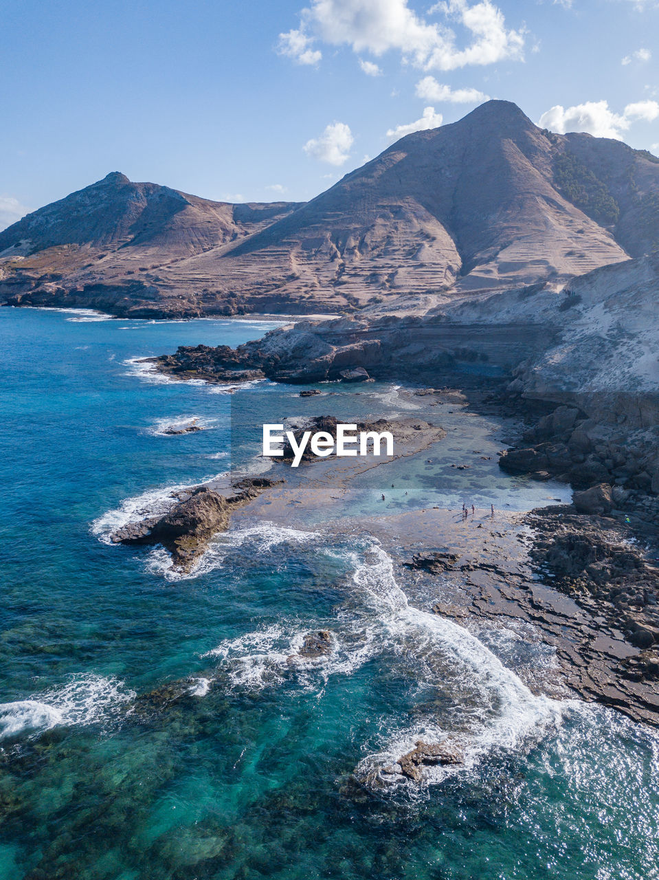 Scenic view of sea and mountains against sky