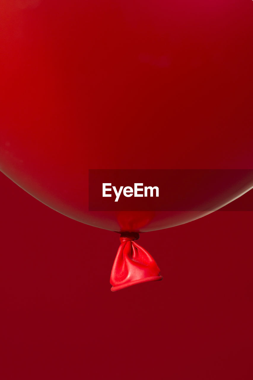 Close-up of balloon against red background
