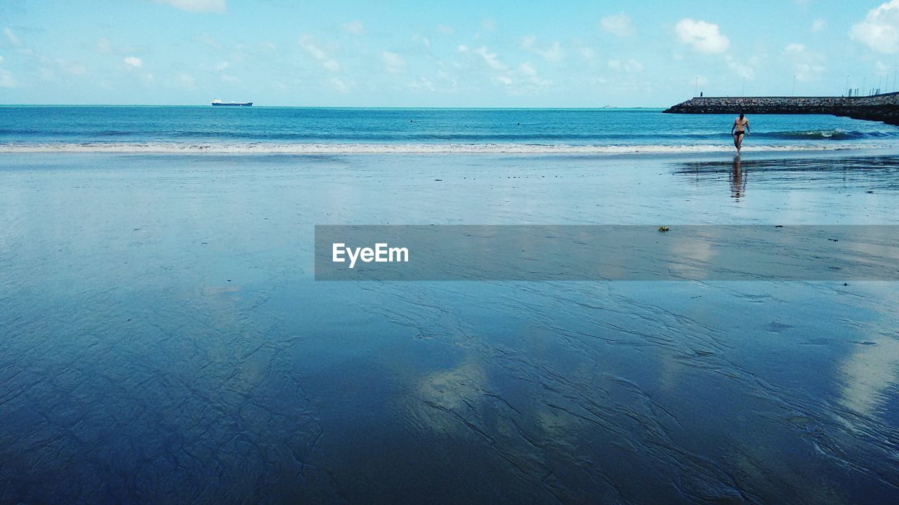 Idyllic view of beach against sky