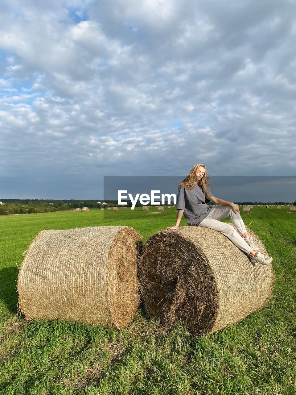 rear view of man standing on grassy field against sky