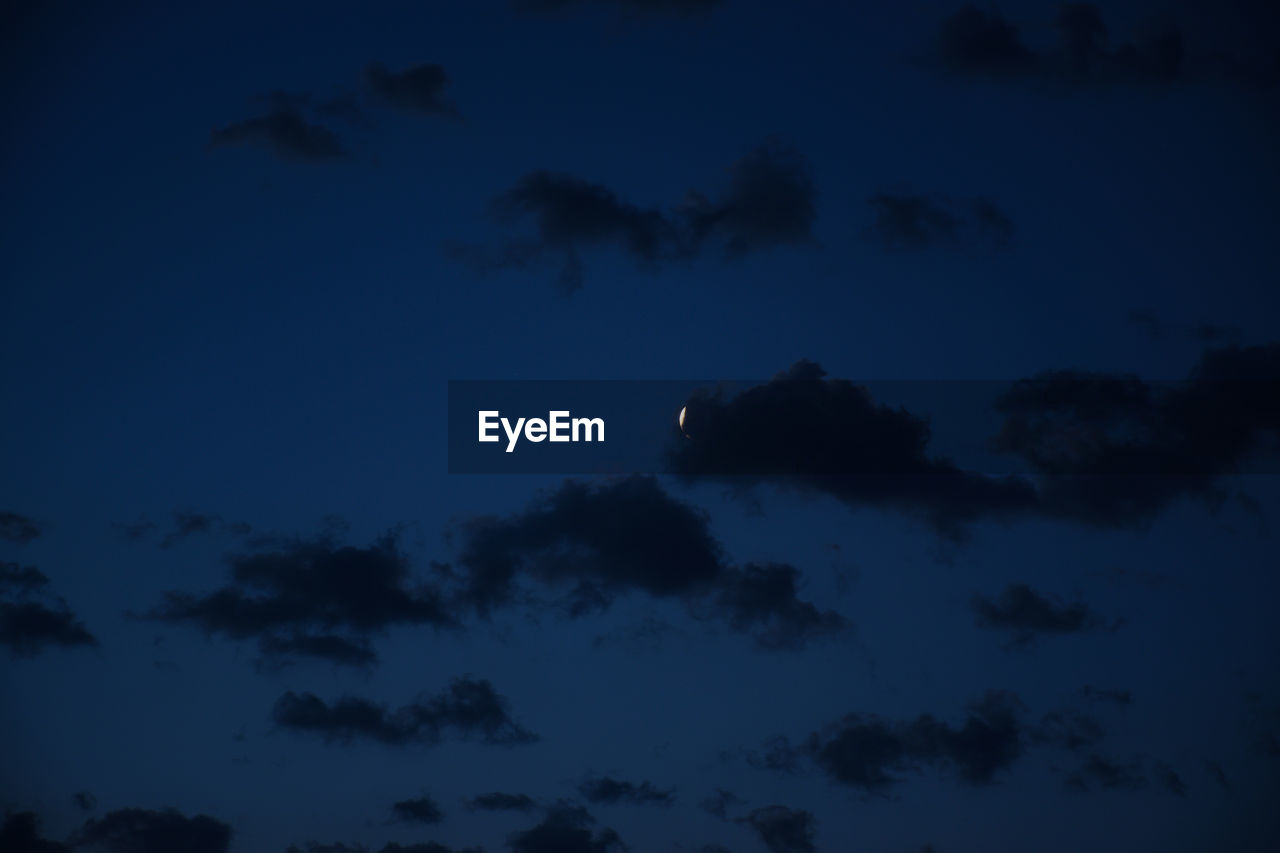 LOW ANGLE VIEW OF SILHOUETTE MOON AT NIGHT