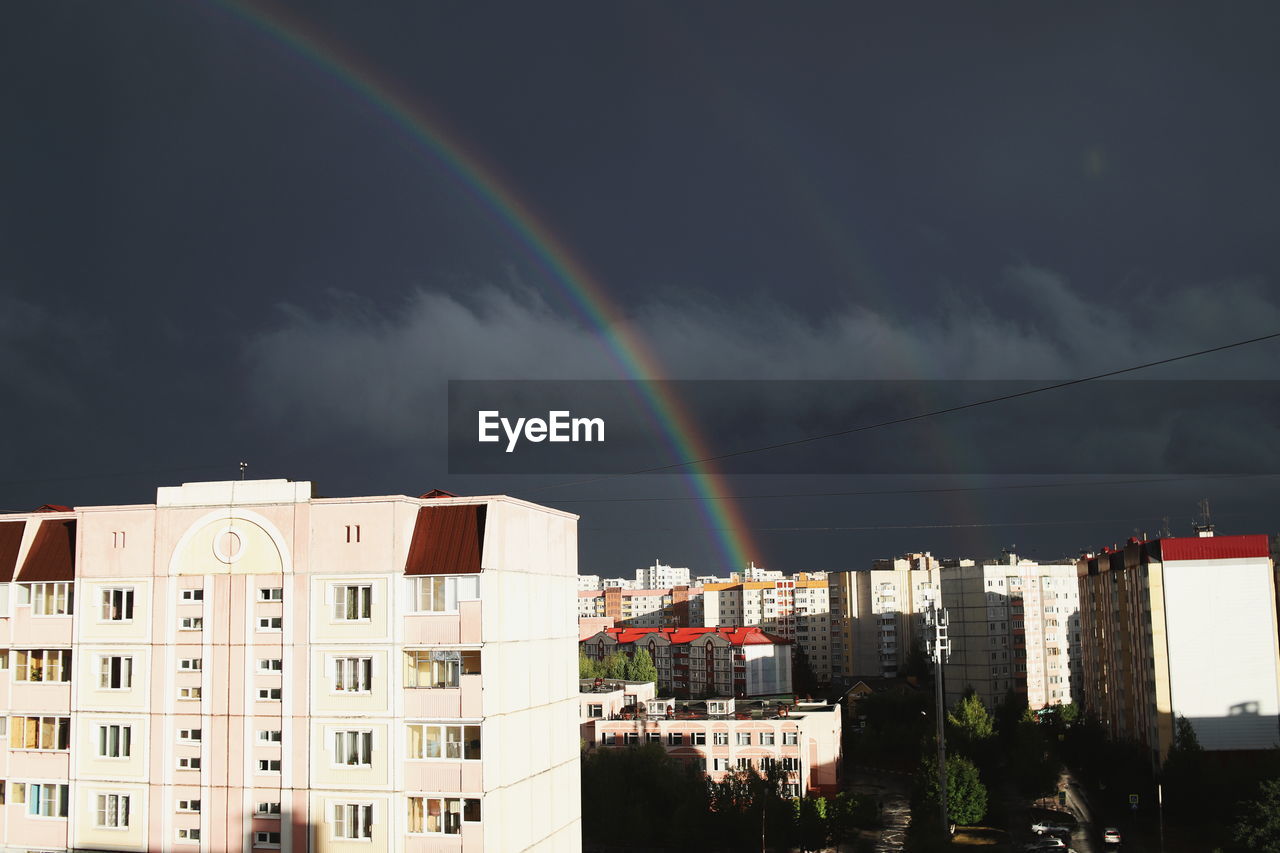 RAINBOW OVER CITY BUILDINGS