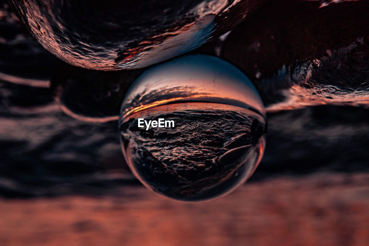 Close-up of crystal ball on wooden surface