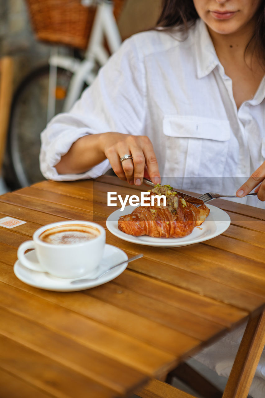 midsection of woman having breakfast