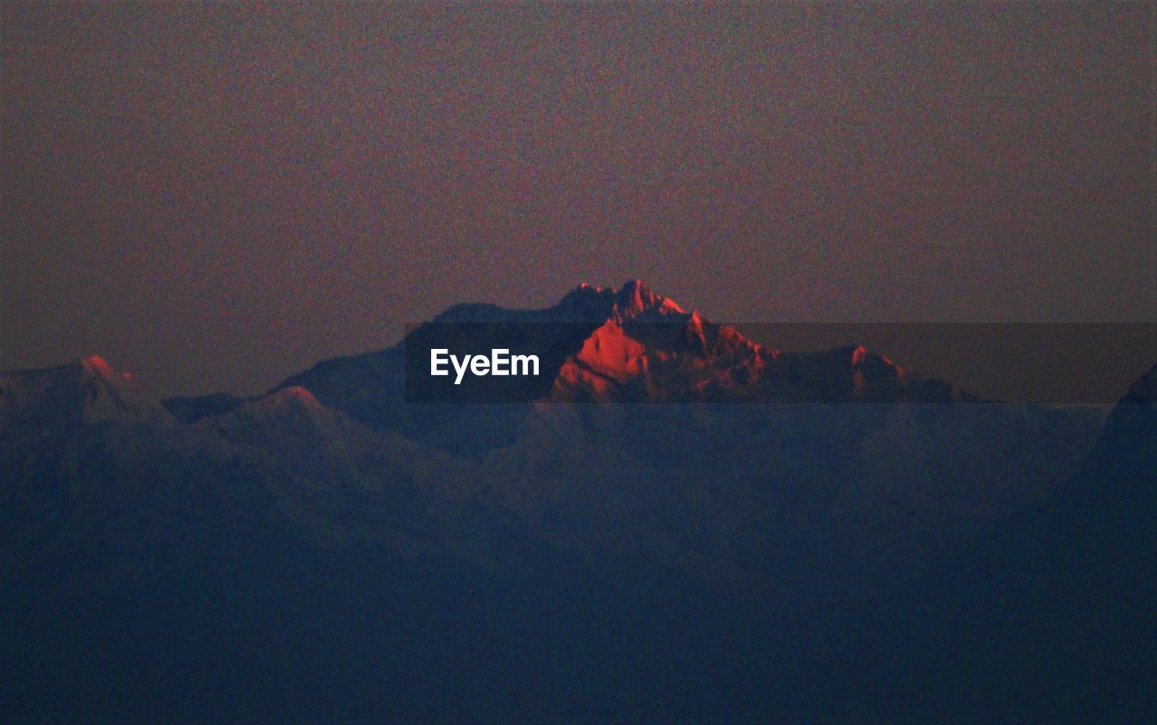 SCENIC VIEW OF SNOWCAPPED MOUNTAINS AGAINST SKY AT SUNSET