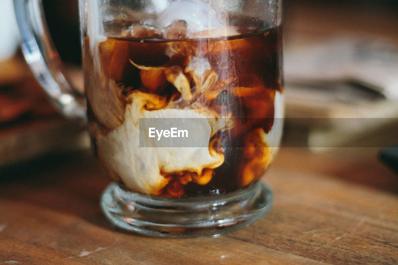 Close-up of iced coffee in glass on table