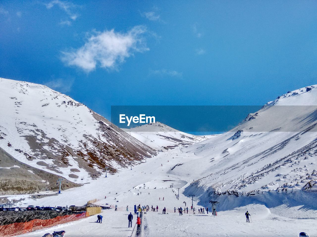 PEOPLE ON SNOWCAPPED MOUNTAINS AGAINST SKY