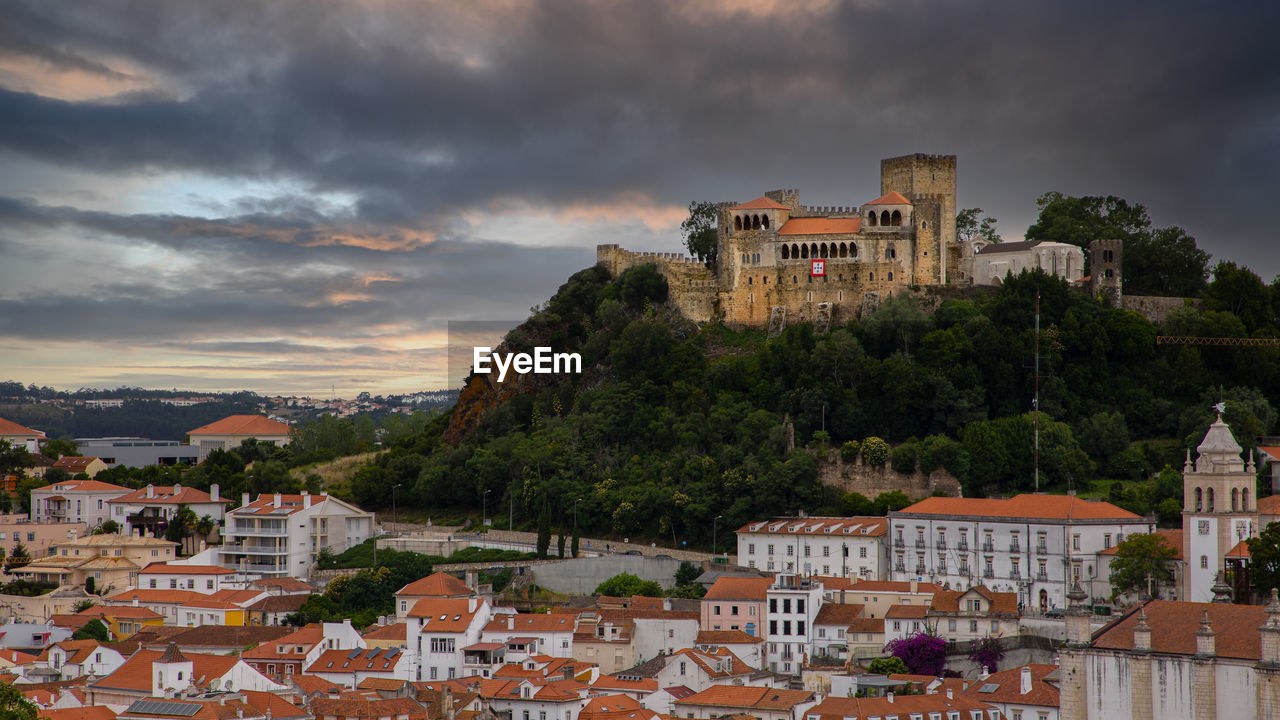 Buildings in town against sky