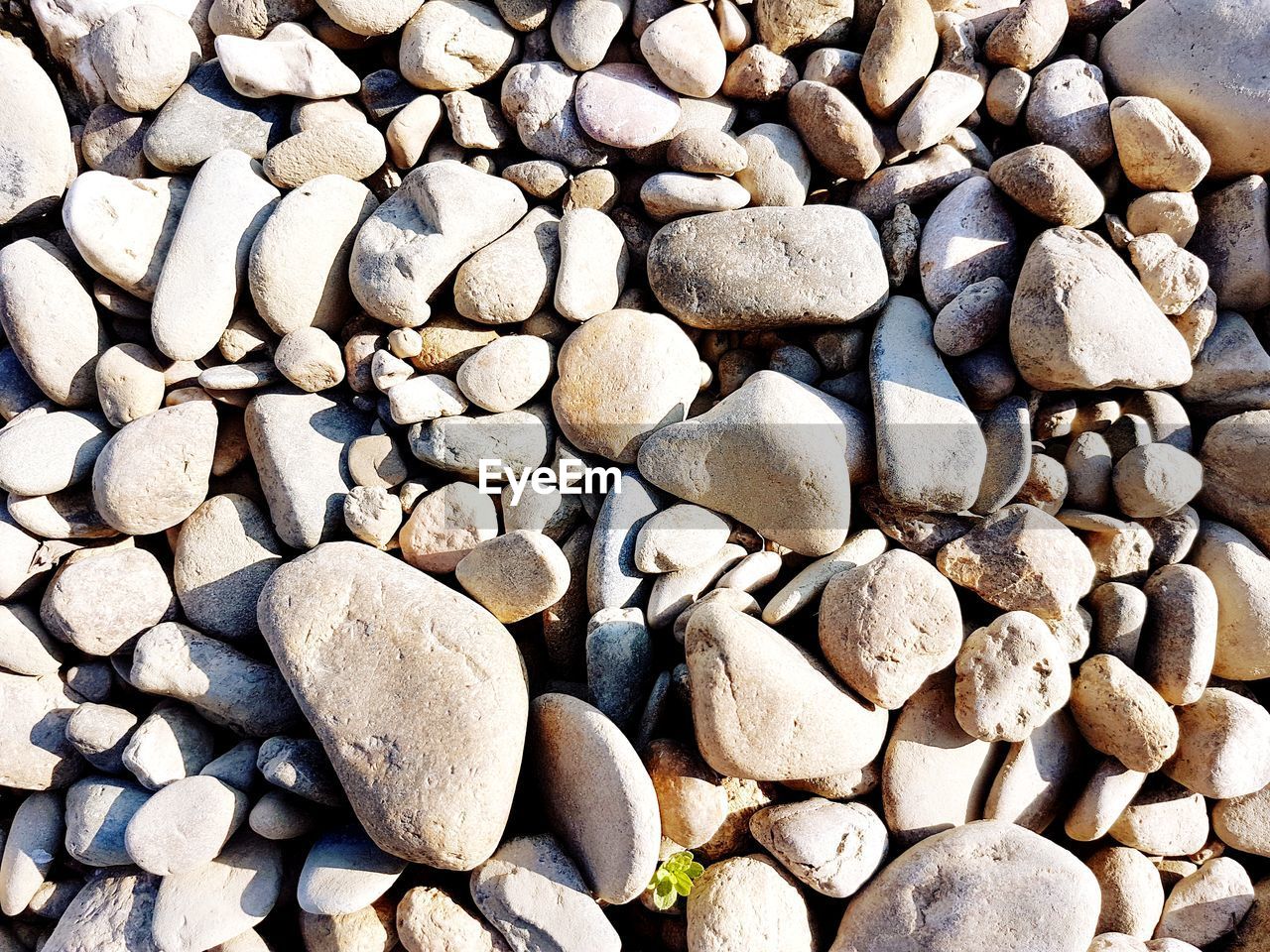 HIGH ANGLE VIEW OF STONES ON BEACH