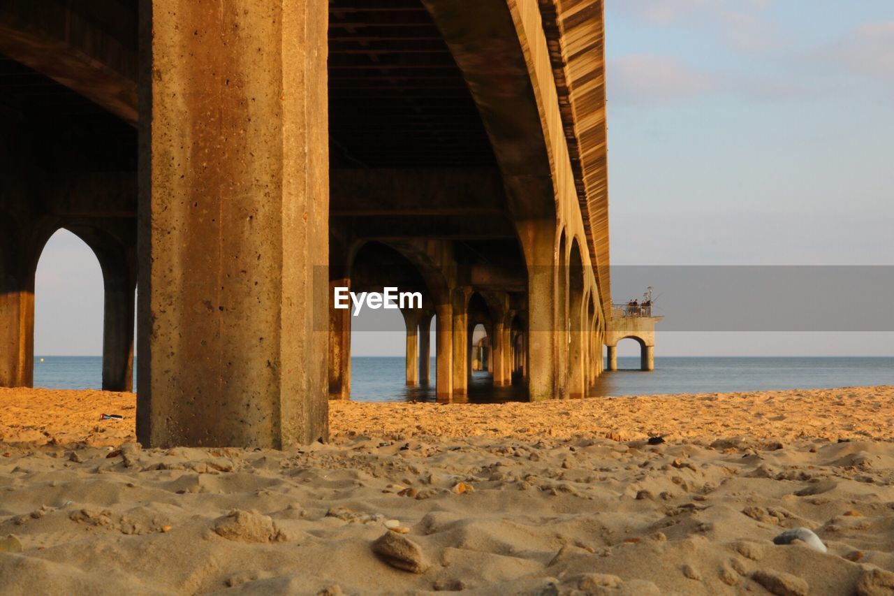 Built structure on beach against sky