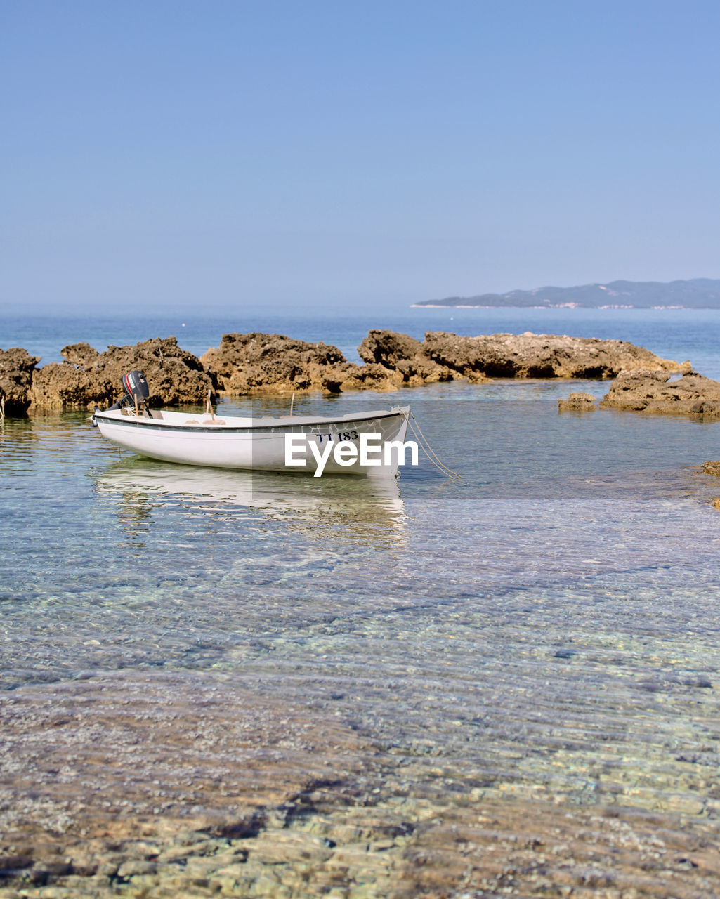 water, shore, sea, coast, nautical vessel, transportation, vehicle, beach, nature, bay, sky, land, ocean, boat, mode of transportation, horizon, no people, travel, scenics - nature, day, clear sky, wave, beauty in nature, blue, tranquility, sand, travel destinations, watercraft, ship, outdoors, rock, tranquil scene, environment, sunny, body of water, coastline, tourism, non-urban scene