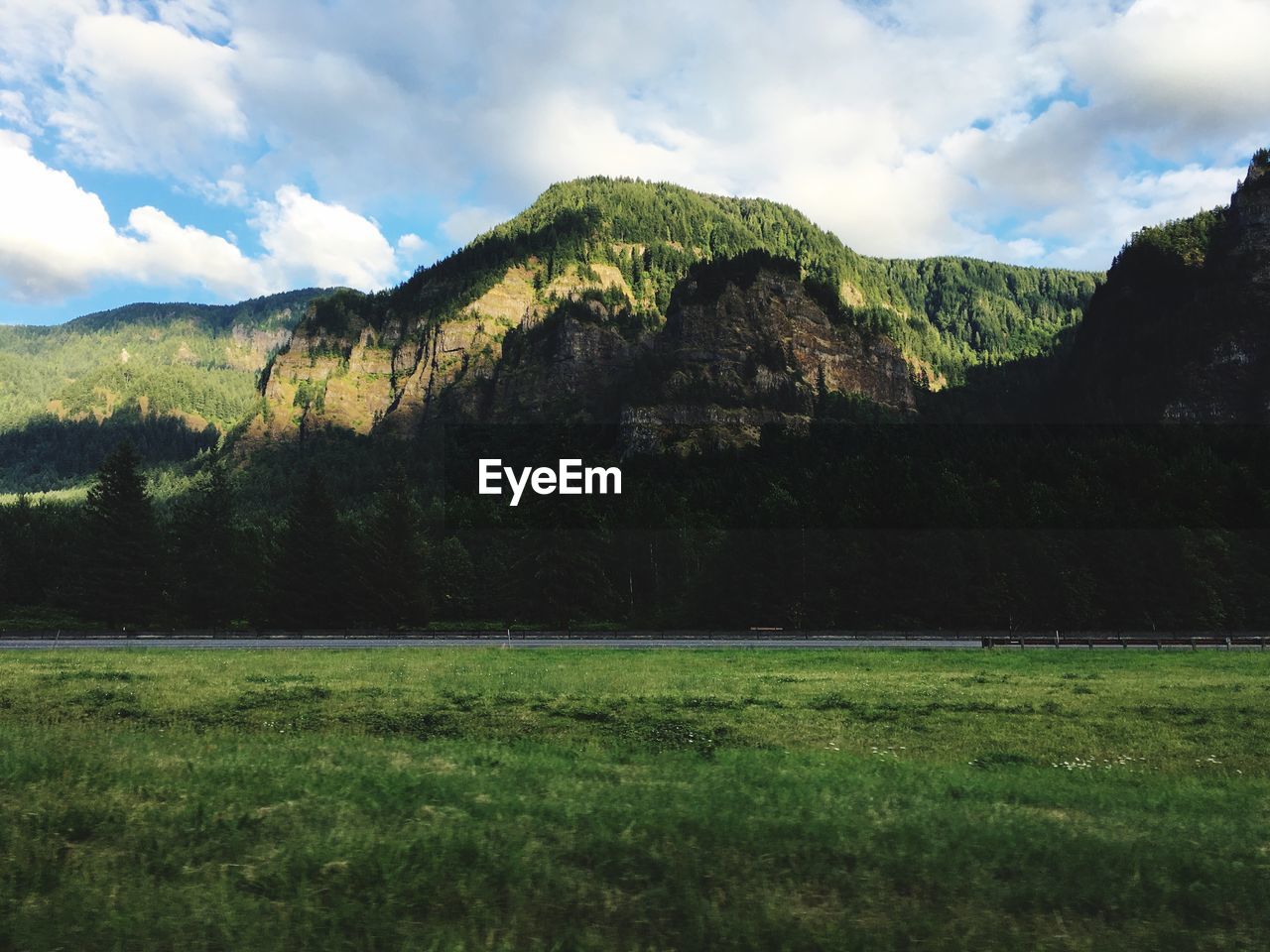 Scenic view of mountains against cloudy sky